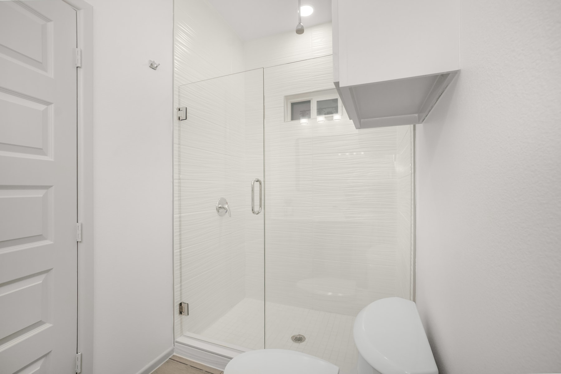 Sugar Mills bathroom shower with glass enclosure and tile surround