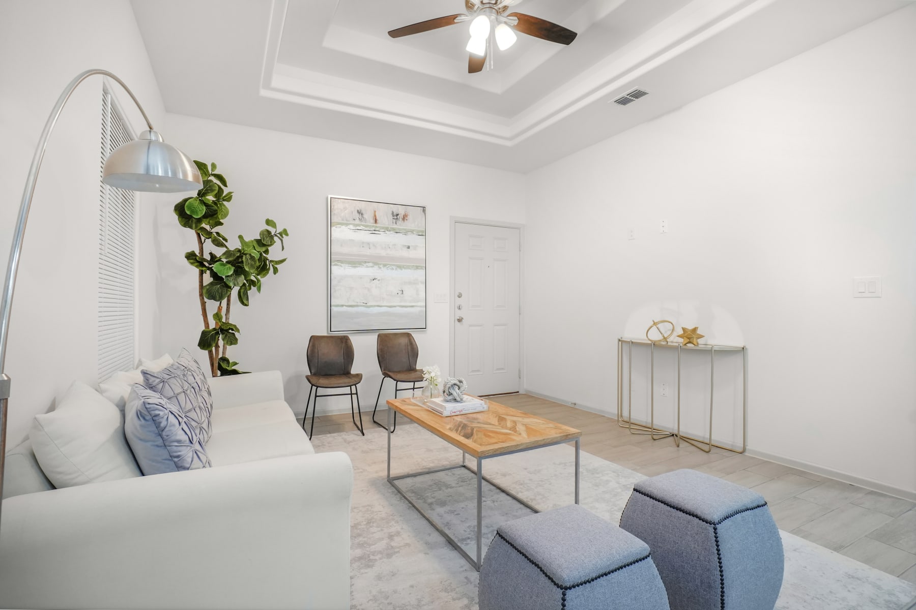 Sugar Mills living area with seating and decorative console styling