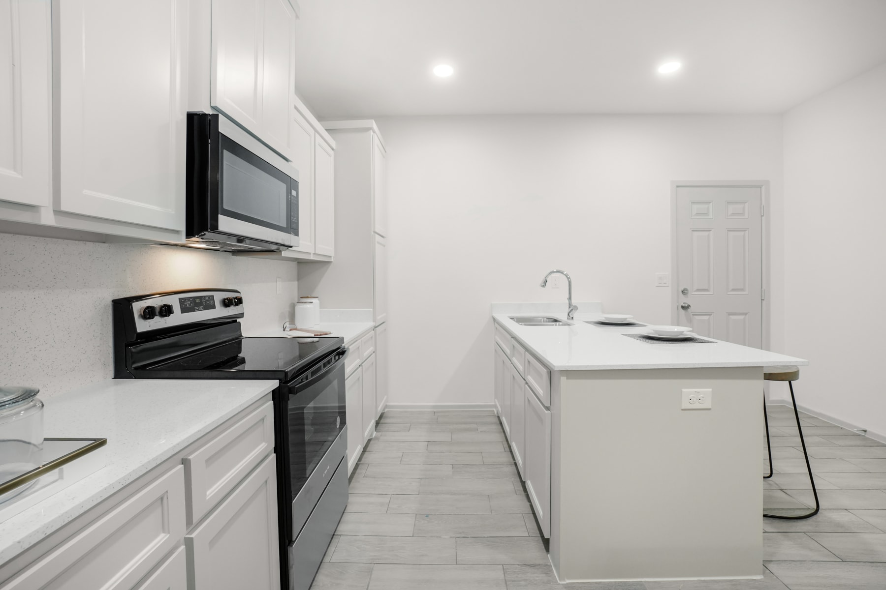 Sugar Mills kitchen corridor view with white shaker cabinetry