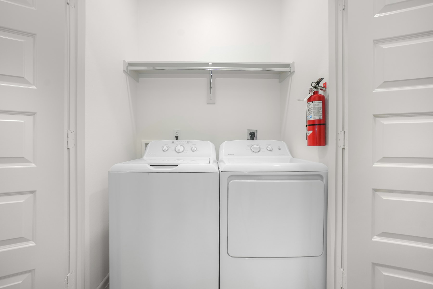 Sugar Mills laundry room with side-by-side washer and dryer