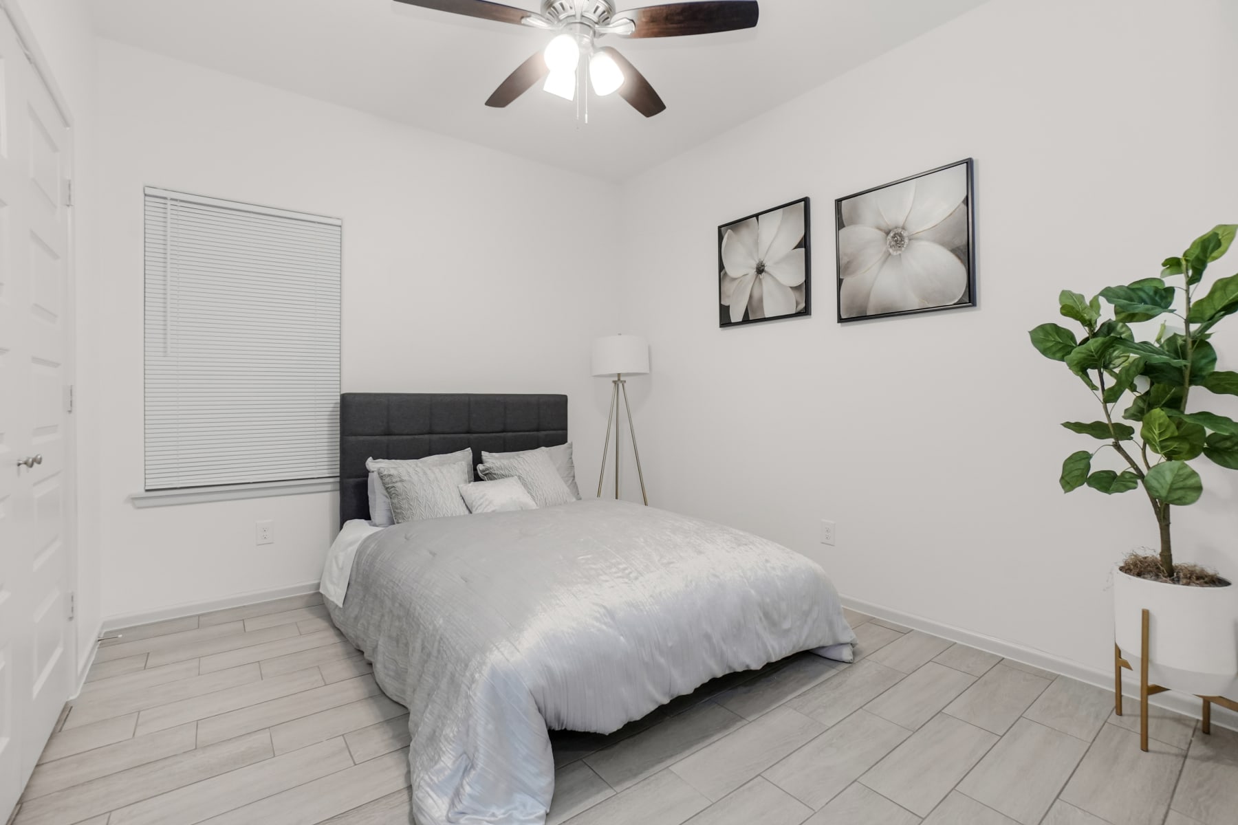 Sugar Mills bedroom with dark headboard and neutral staging