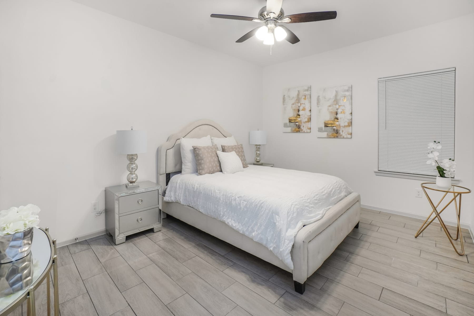 Sugar Mills bedroom with upholstered bed and light tile flooring