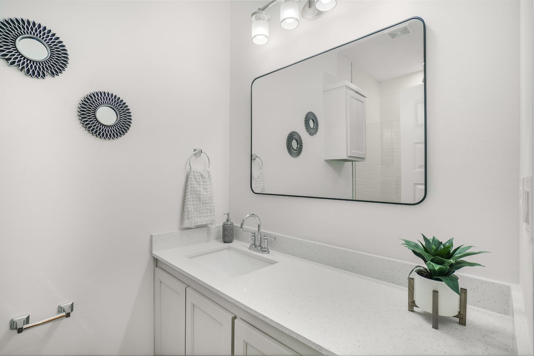 Sugar Mills vanity close-up with framed mirror and clean white finishes