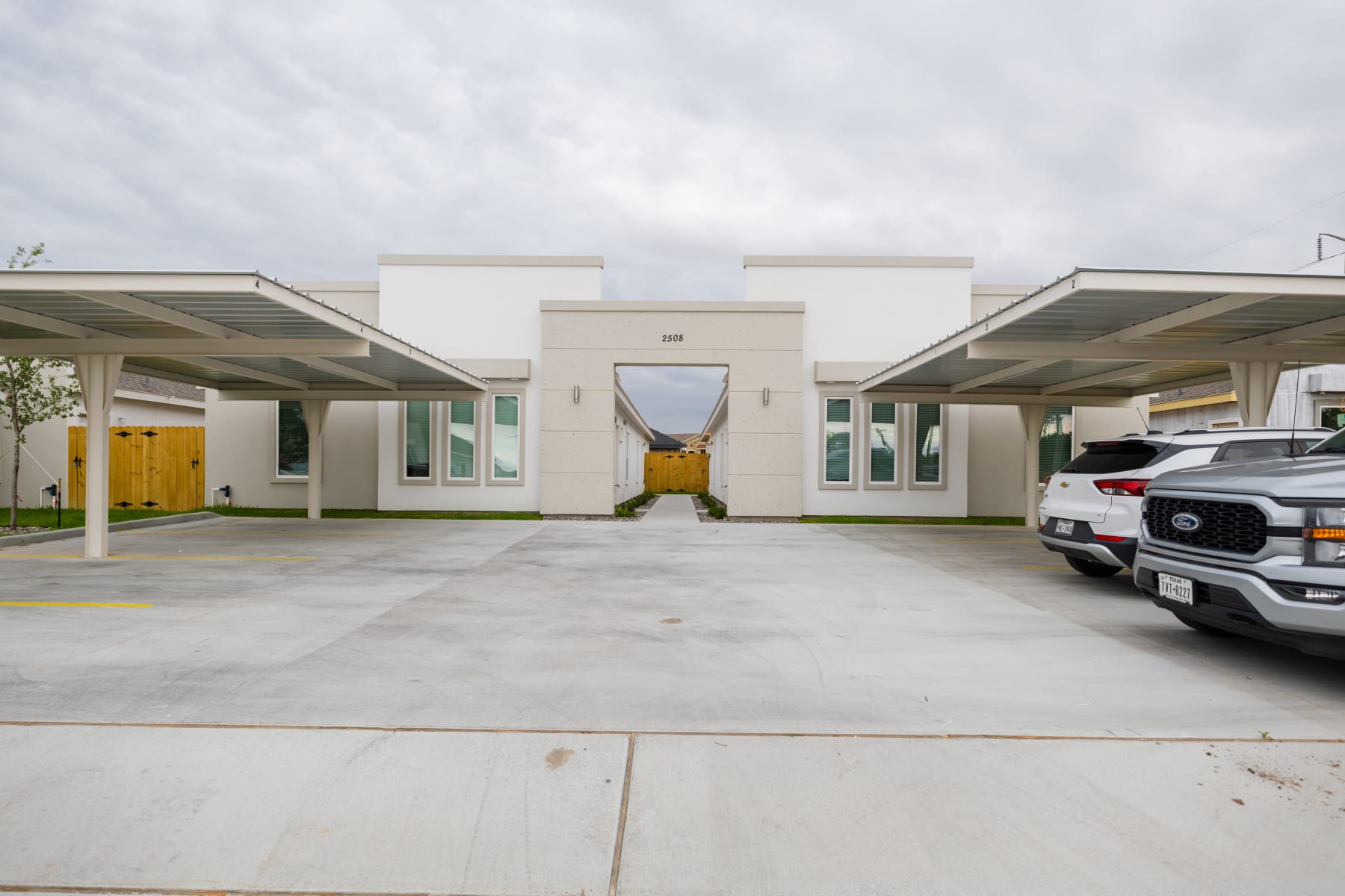 Front entry archway and covered carports at a Westwood Villas building
