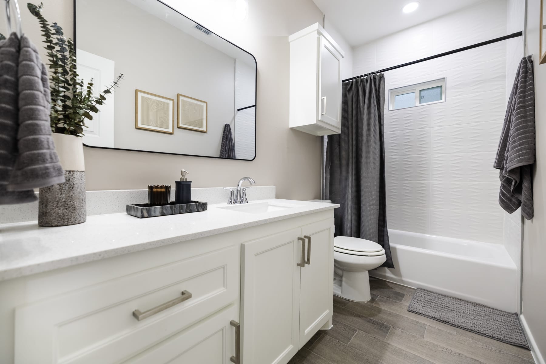 Kitchen view showing black appliances, white cabinetry, and access to a rear door at Westwood Villas