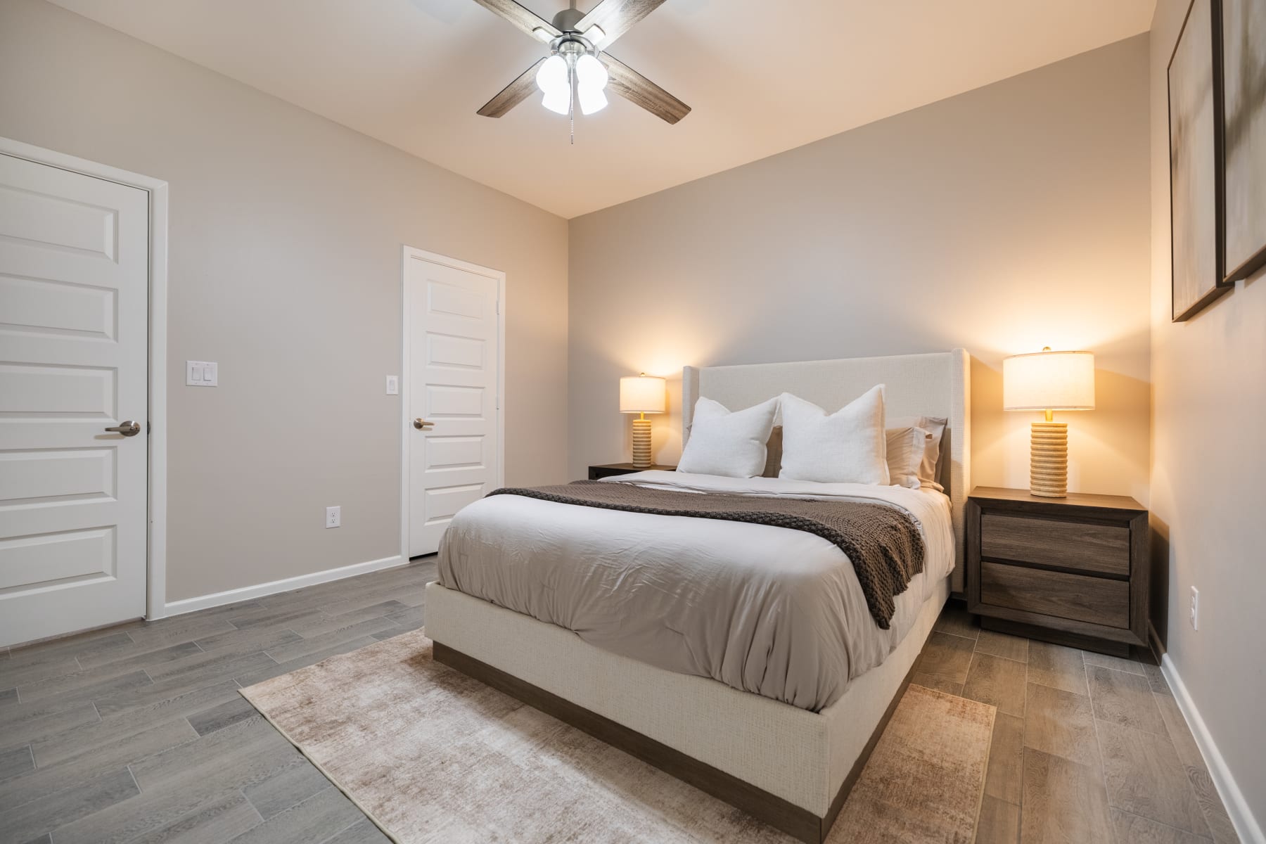Spacious primary bedroom view showing doors and tile flooring at Westwood Villas