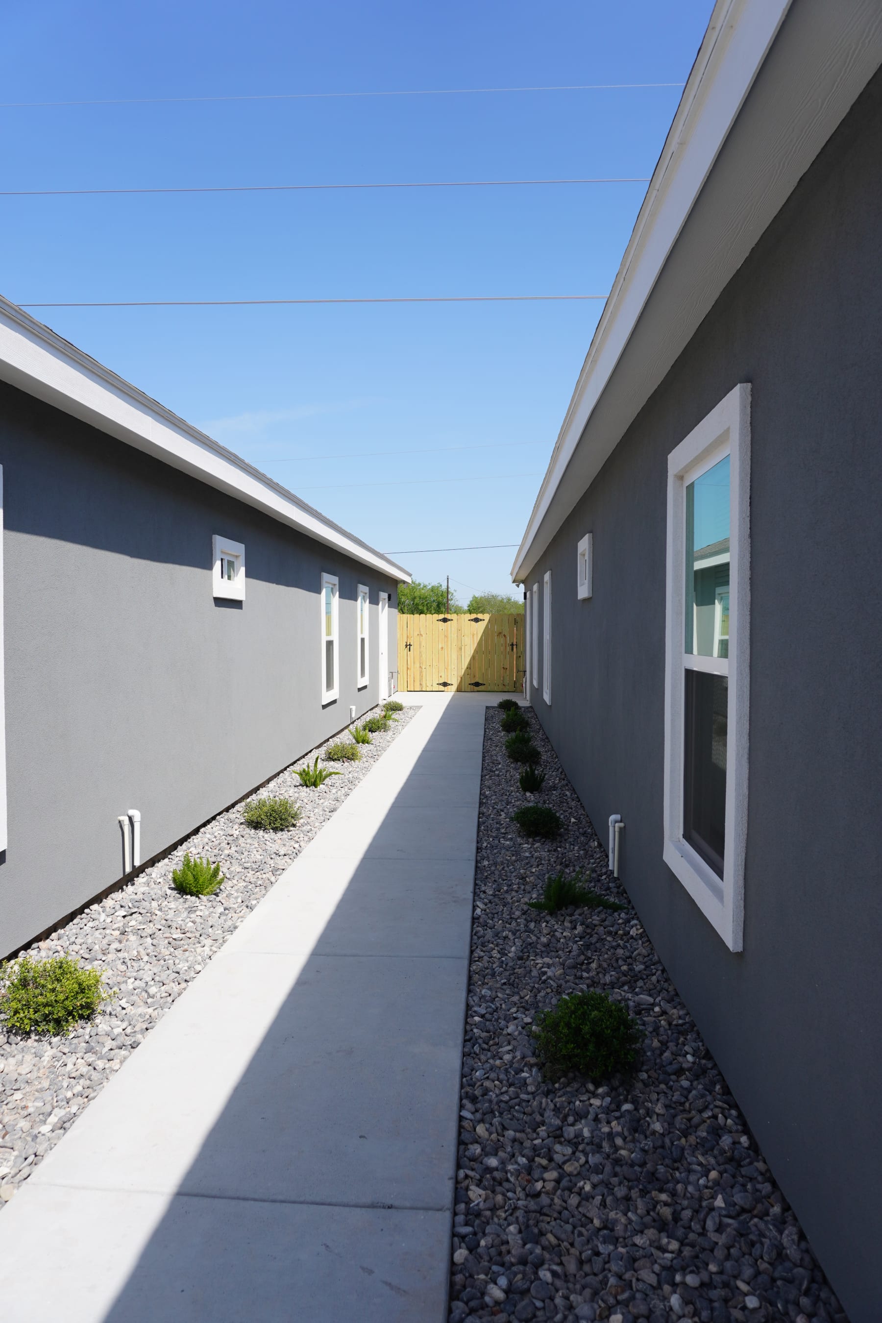 Concrete path walkway between the OakView Sixplexes buildings