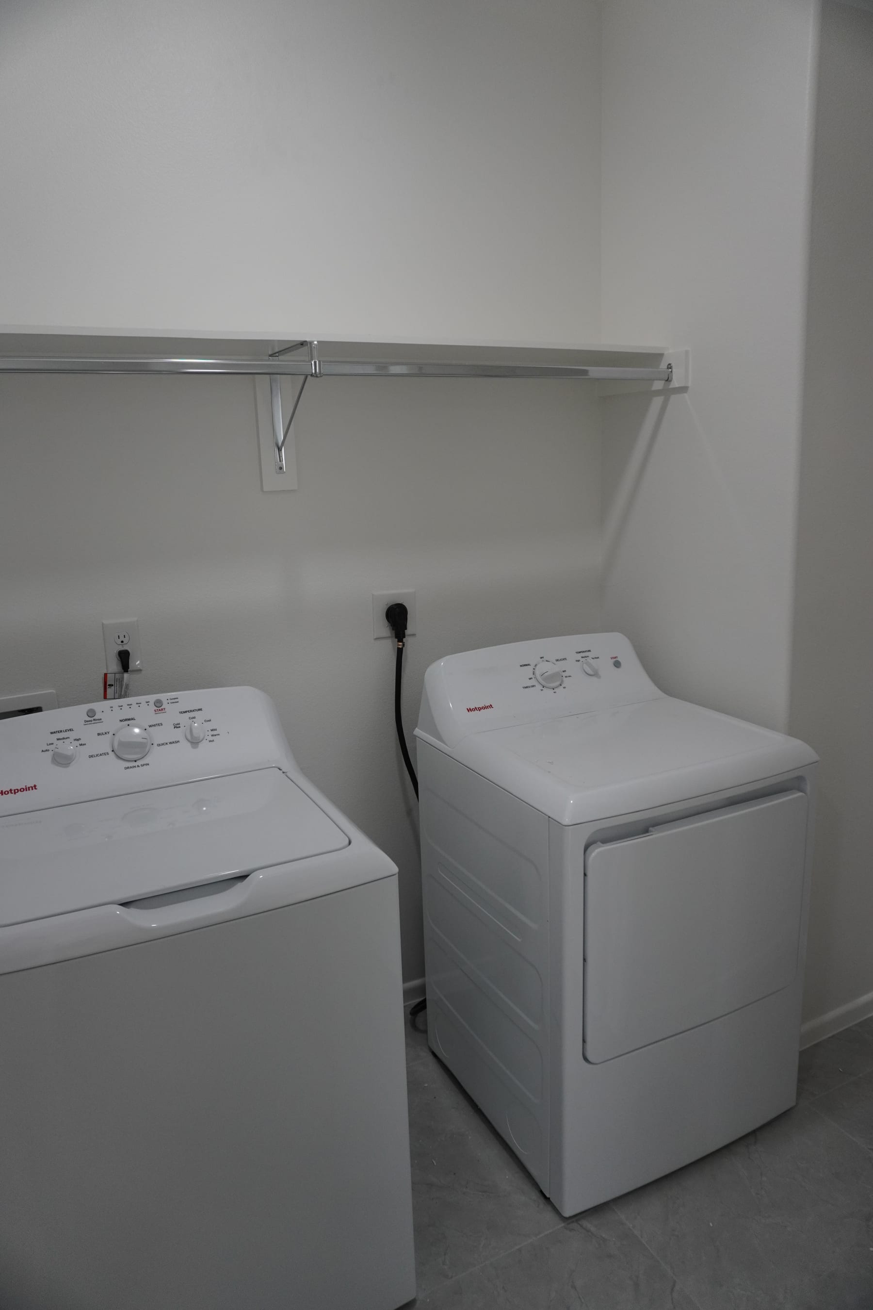 Laundry closet with side-by-side washer and dryer units