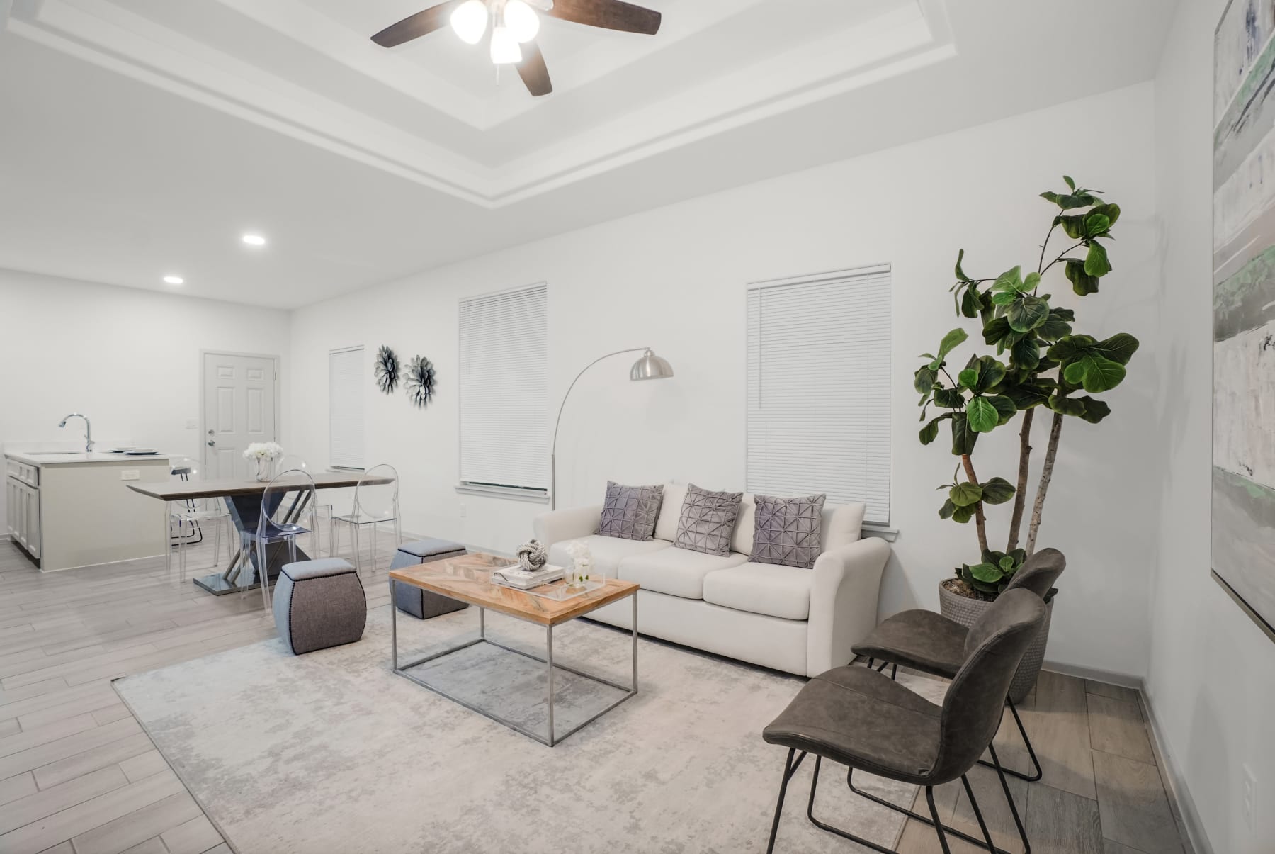 Sugar Mills living room with open kitchen view and light neutral finishes