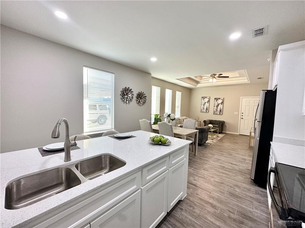 View across the Dawson Estates kitchen island and double sink toward the dining and living area