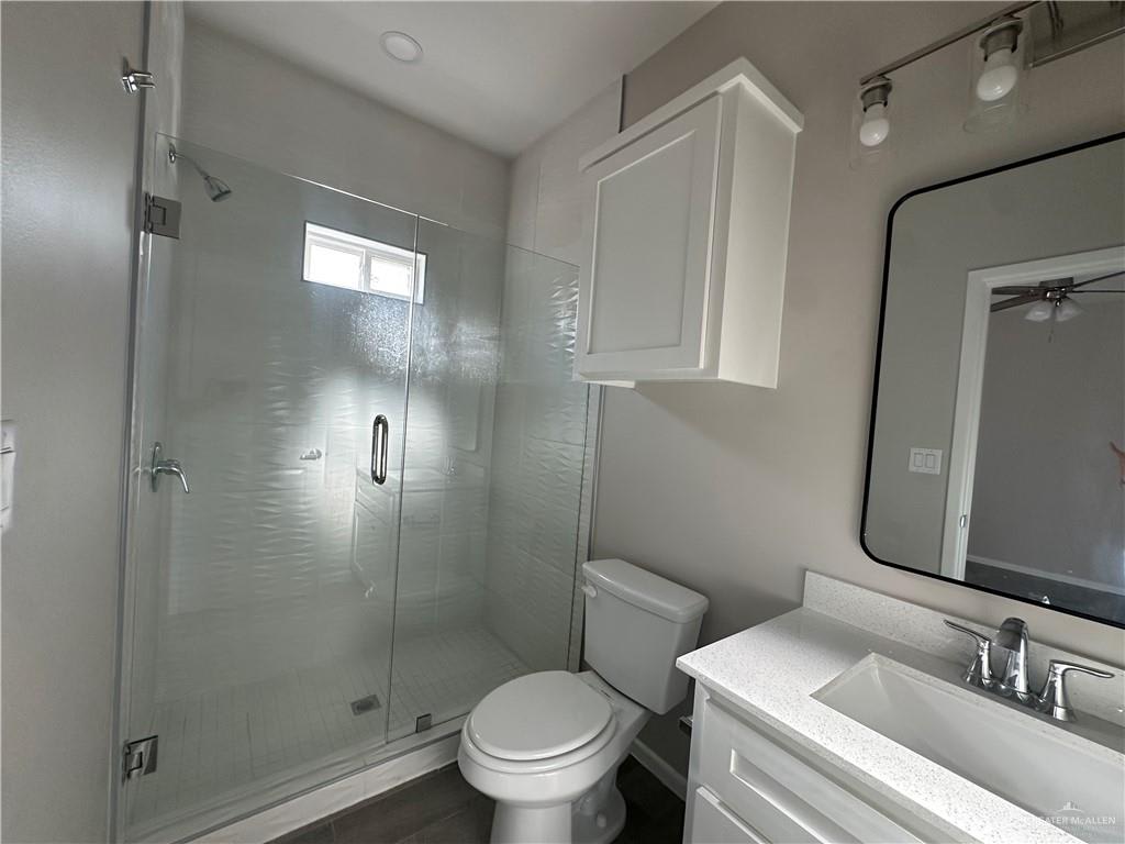 Riverside Tower bathroom with a frameless glass shower and a black-framed mirror