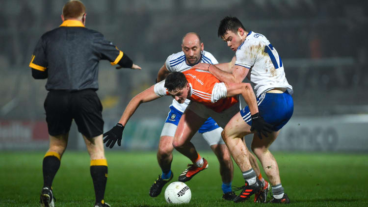 Connaire Mackin of Armagh in action against Gavin Doogan and Barry Kerr, right, of Monaghan, as referee Barry Cassidy looks on, during the Bank of Ireland Dr McKenna Cup Round 3 match between Armagh and Monaghan at the Athletic Grounds in Armagh.