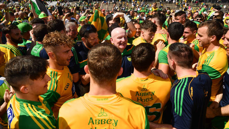 Declan Bonner celebrates with players and supporters at St Tiernach's Park in Clones.