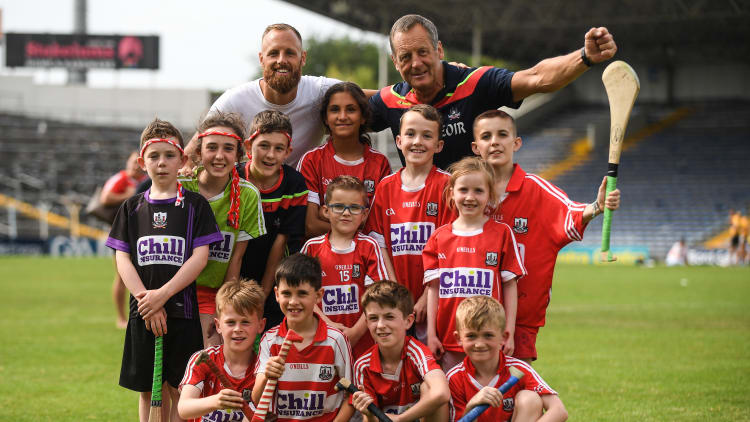 Cork manager John Meyler with his son and Republic of Ireland footballer David Meyler and Cork supporters from Bride Rovers GAA club after victory over Clare in the Munster SHC Final.