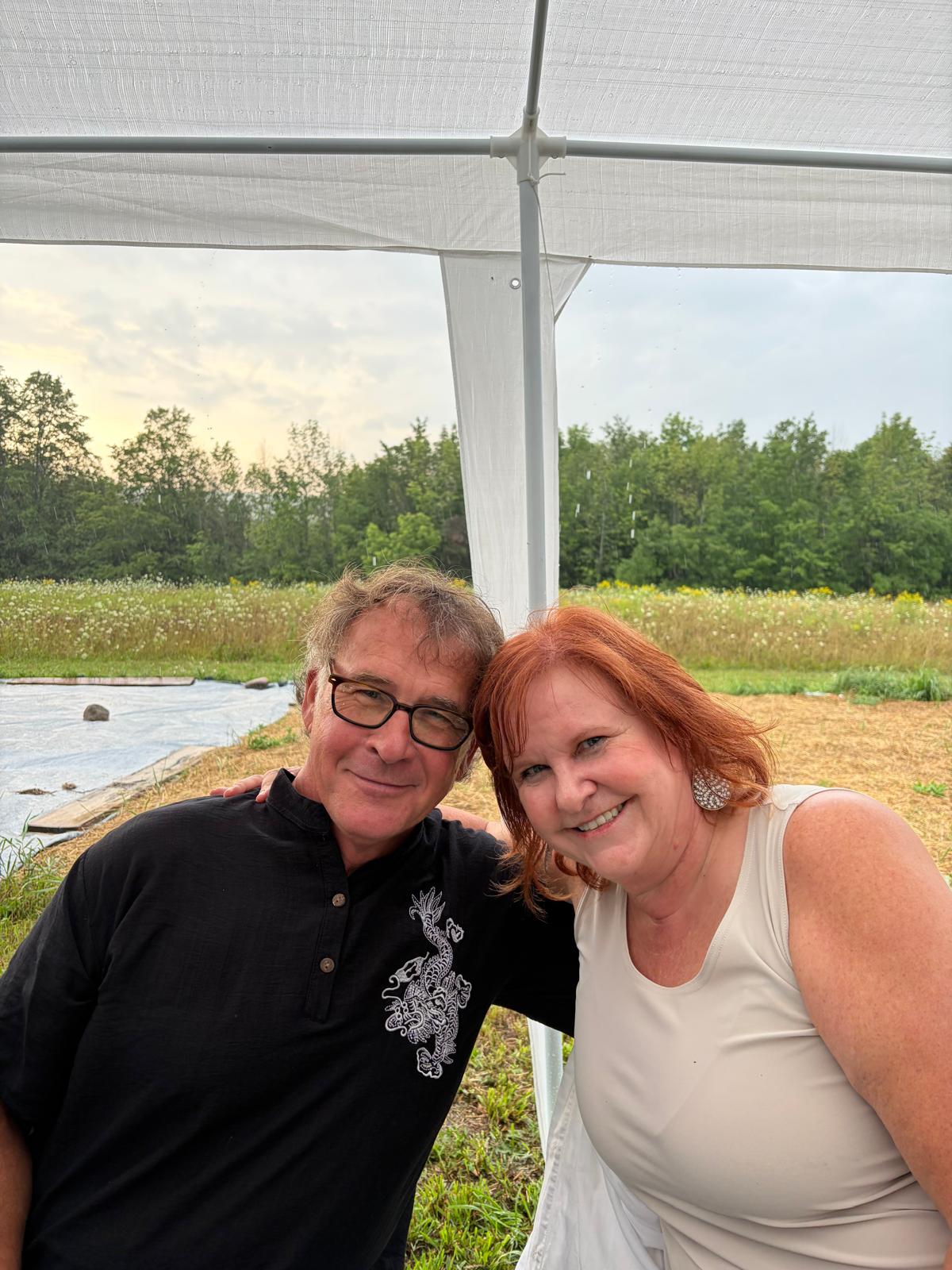 A couple smiling under the tent