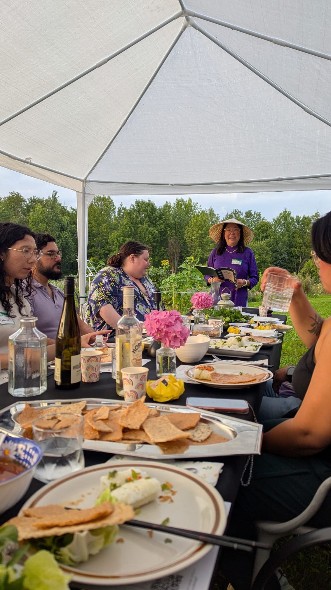 Thu reading a poem to seated guests