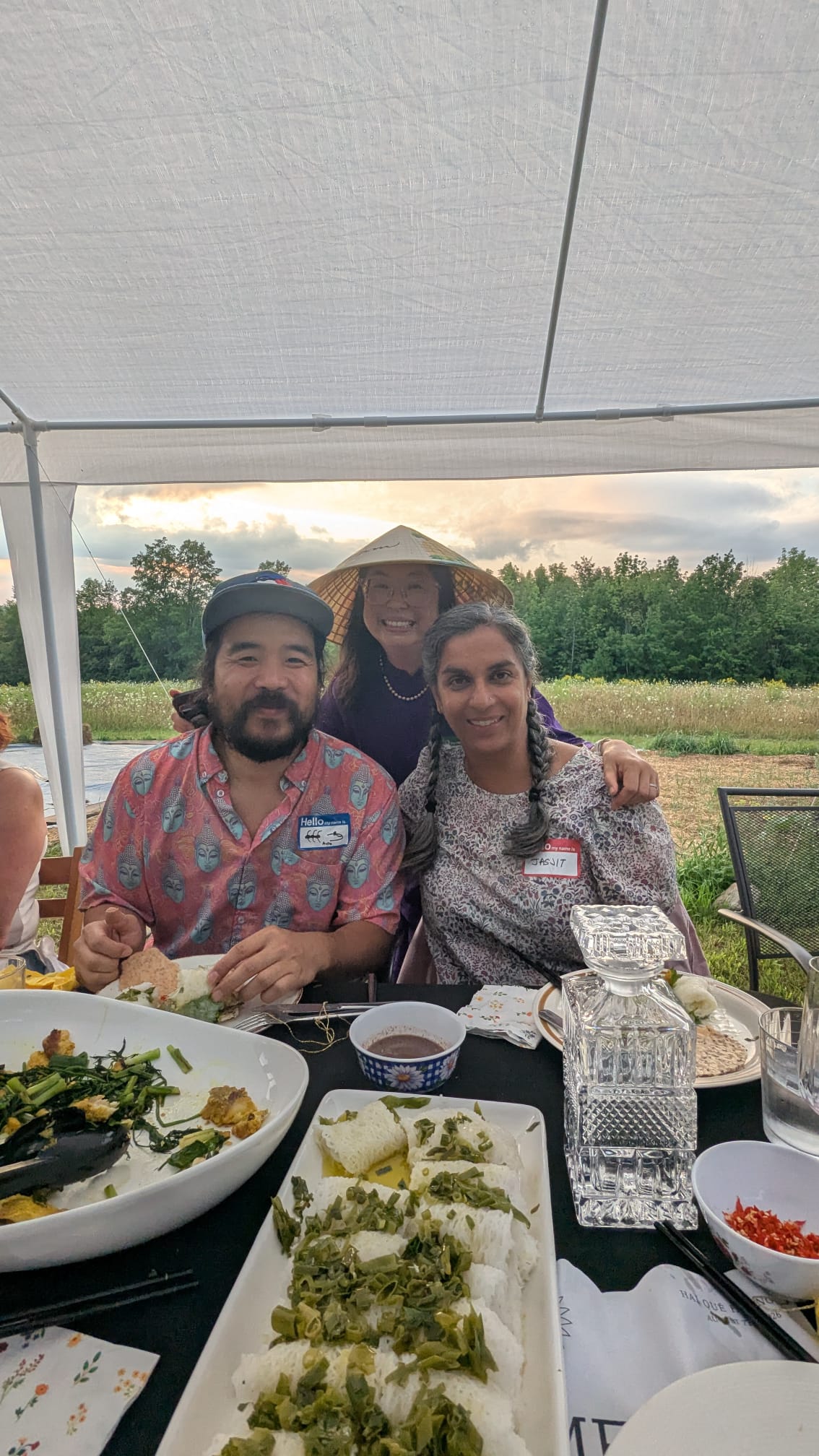 Three guests smiling together at the table