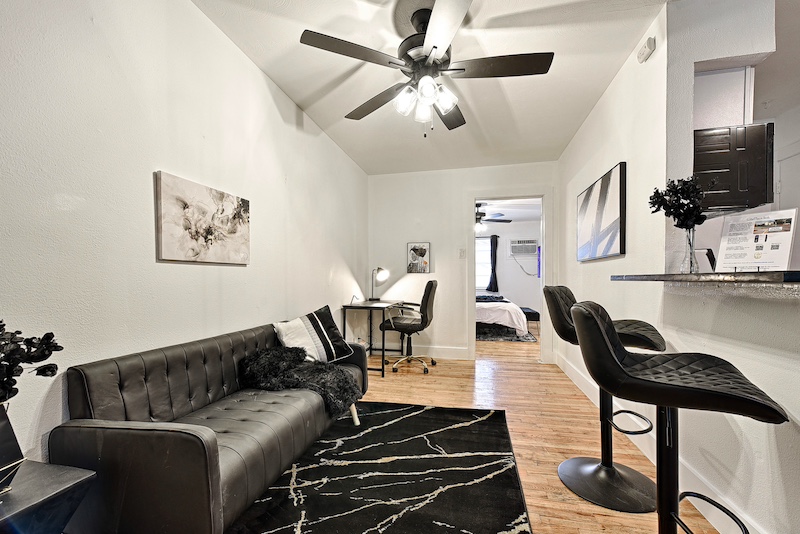 Comfortable living area with couch, chair, and workspace