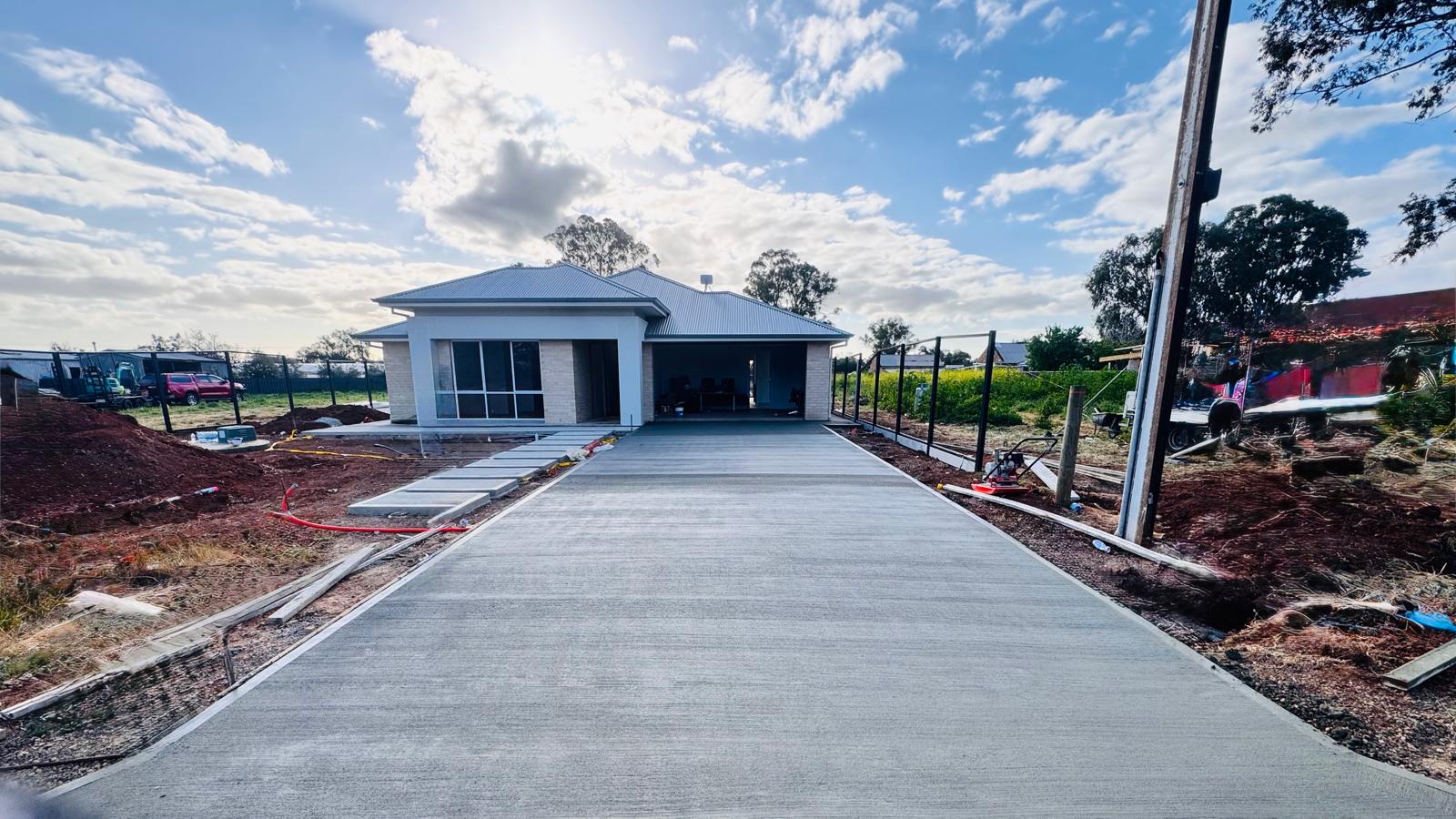 Standard plain grey concrete driveway broom finish