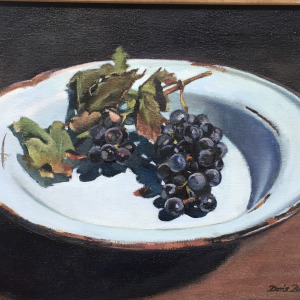 Wine grapes on old enamel plate