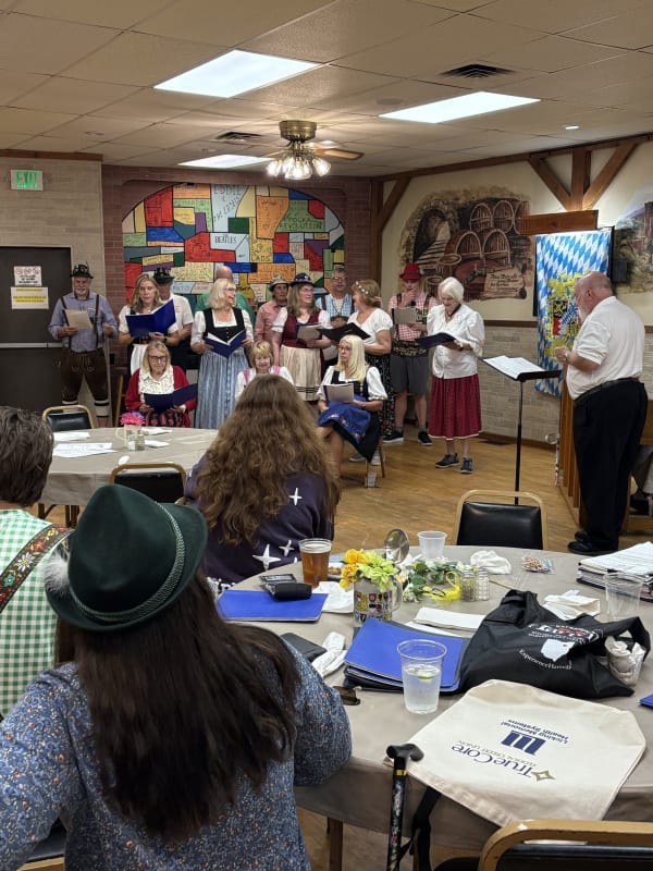 The combined choirs singing Oktoberfest songs