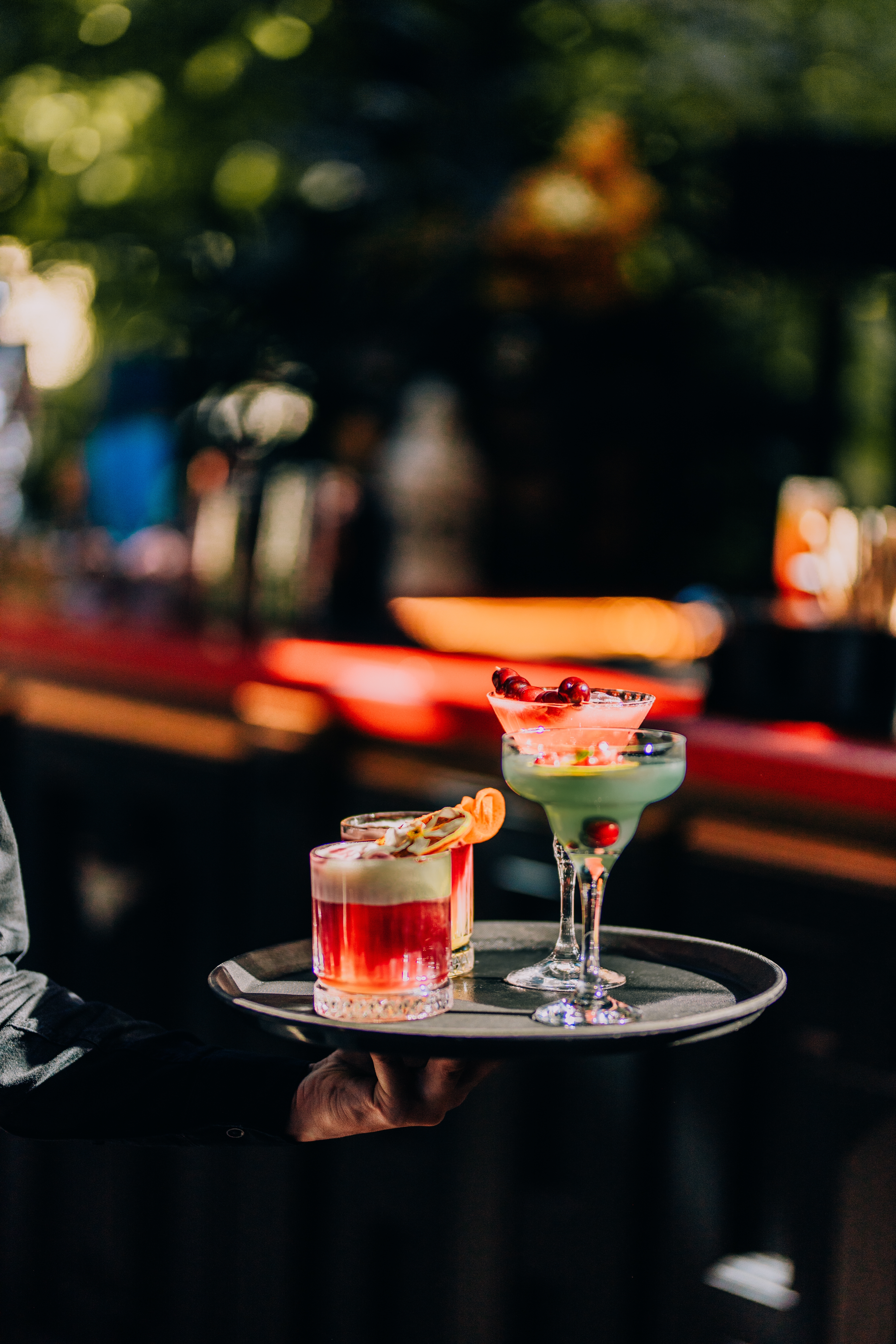 Bartender serving drinks at a professionally managed commercial bar, representing the alcohol-service exposures covered by liquor liability insurance
