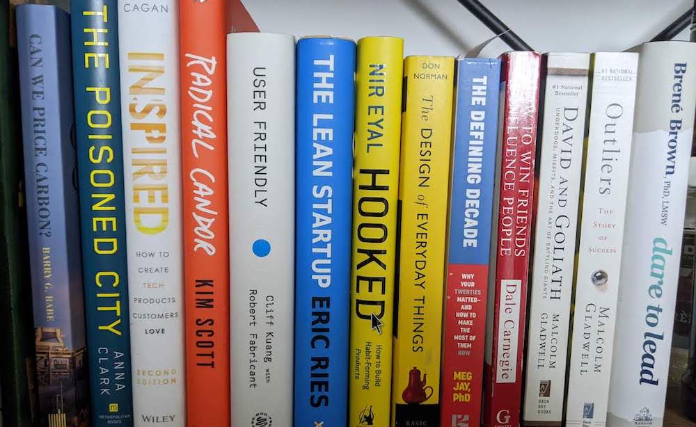 Several professional books are on a shelf.