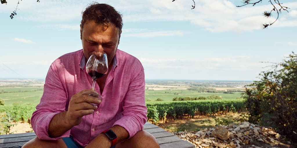 A winemaker drinks tannic red wine