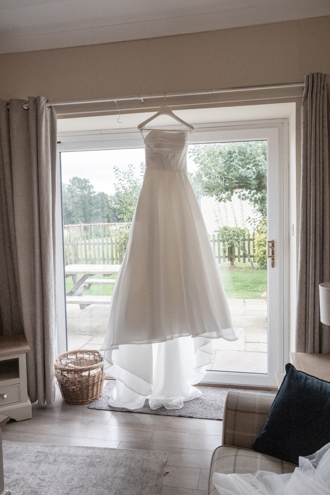 Ellie’s wedding dress hangs in the doorway overlooking the garden