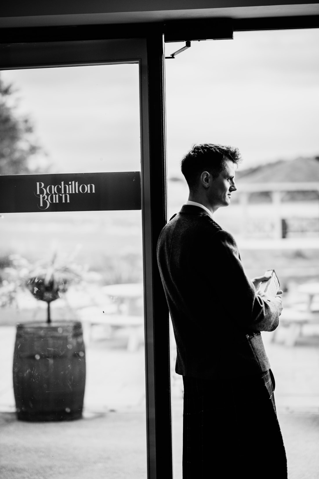 Waiting by the window beside the Bachilton Barn sign