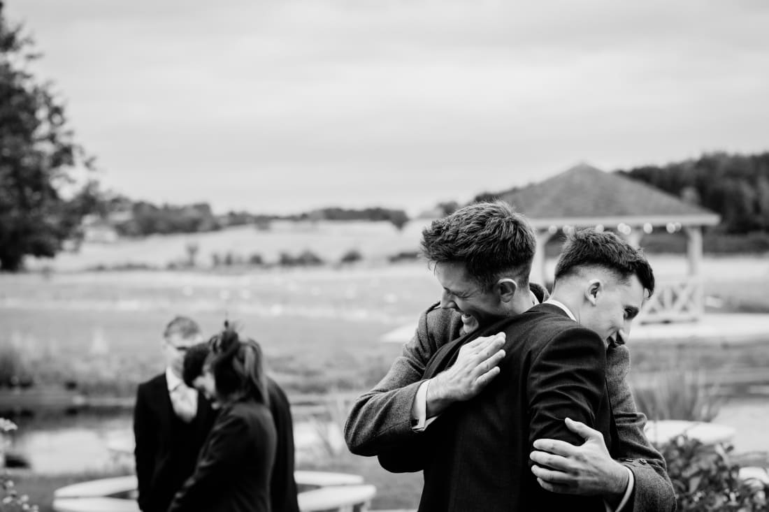 Hugs are shared on the lawn before the ceremony