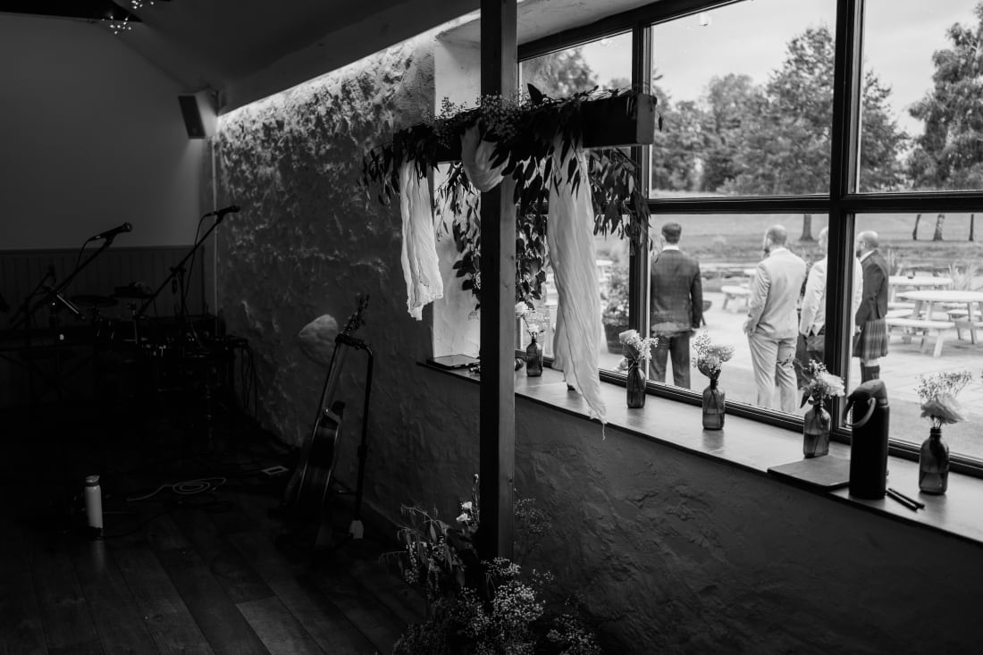Light falls through the barn windows onto the ceremony space