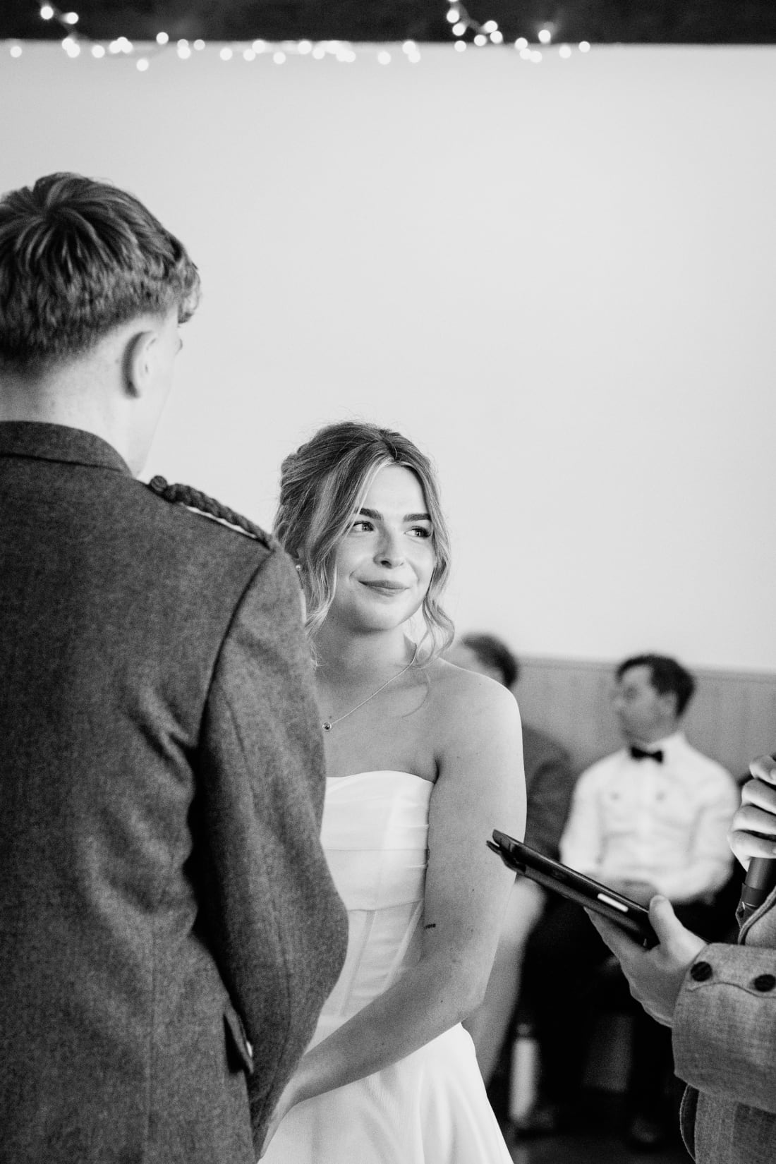 Ellie looks up at Nathan during the ceremony