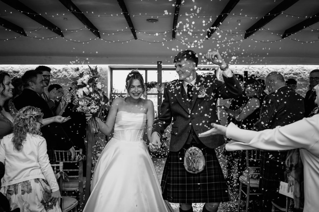 Confetti fills the air as Ellie and Nathan walk back down the aisle