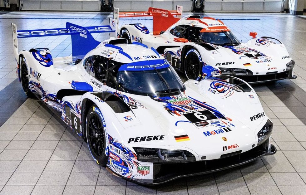 two porsche race cars displayed indoors two porsche race cars displayed indoors