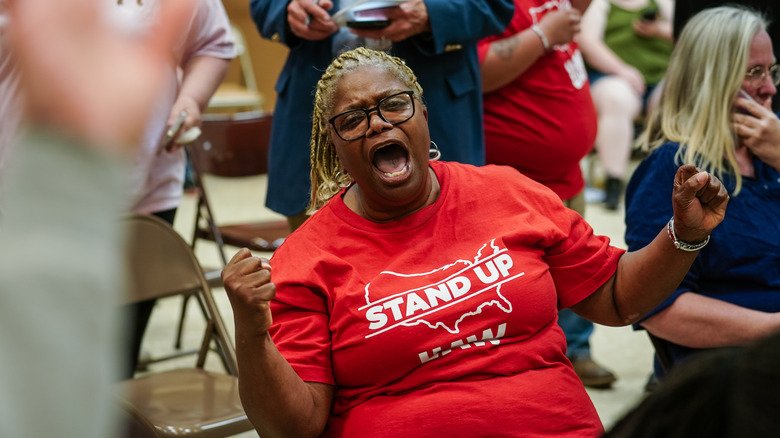 A Volkswagon employee celebrates as results of the unionization vote trickle in at a United Auto Workers vote watch party on April 19, 2024 in Chattanooga, Tennessee. A Volkswagon employee celebrates as results of the unionization vote trickle in at a United Auto Workers vote watch party on April 19, 2024 in Chattanooga, Tennessee.