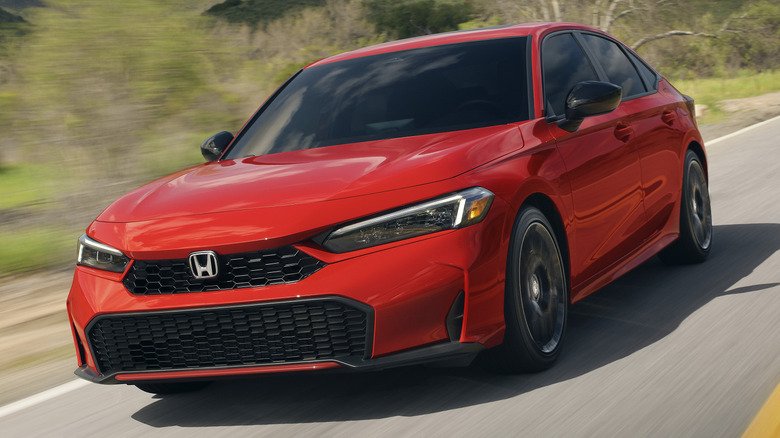 Front 3/4 action shot of a 2025 Honda Civic Sedan Sport Touring Hybrid