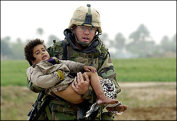Casualties: In March 2003, photographer Warren Zinn took this photo of Army medic Joseph Dwyer with wounded 4-year-old Iraqi Ali Sattar. Dwyer struggled with PTSD and died June 28 of substance abuse.