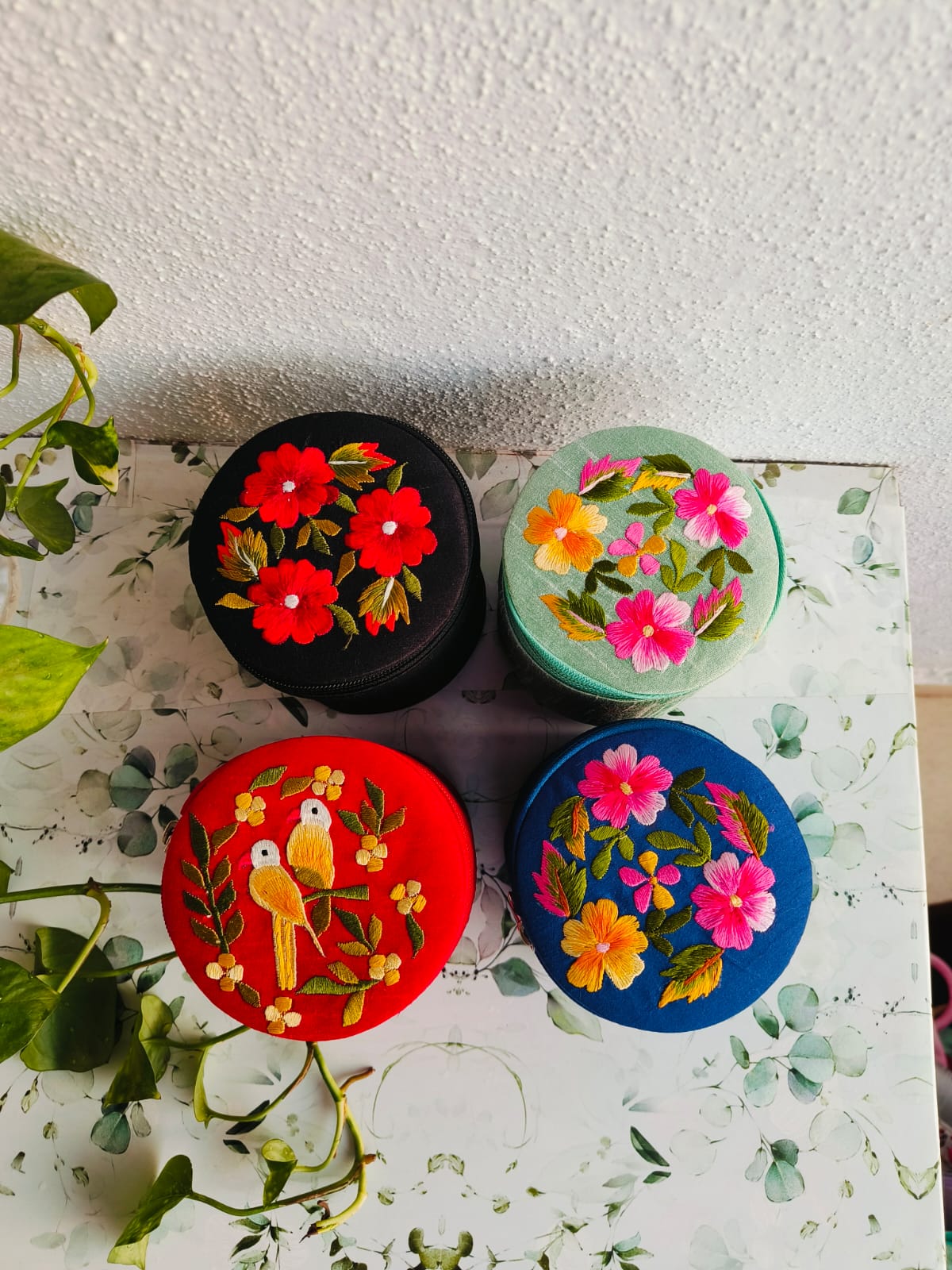 Skilled artisan hand-embroidering traditional Indian patterns on fabric with colorful threads