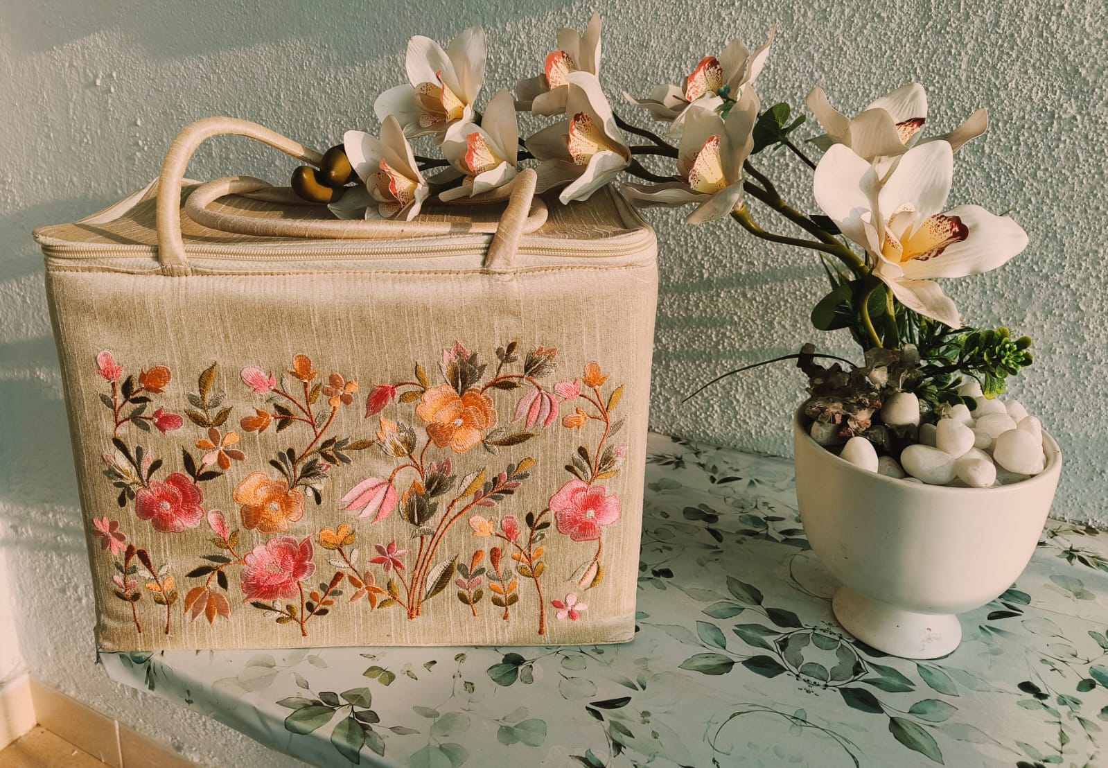 Close-up detail of intricate hand embroidery work showing traditional Indian patterns and colorful threads