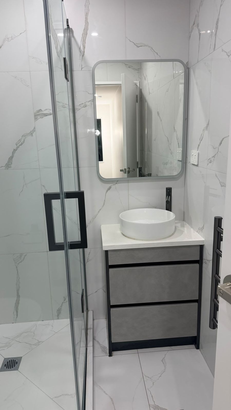 Marble-look bathroom with vanity and mirror