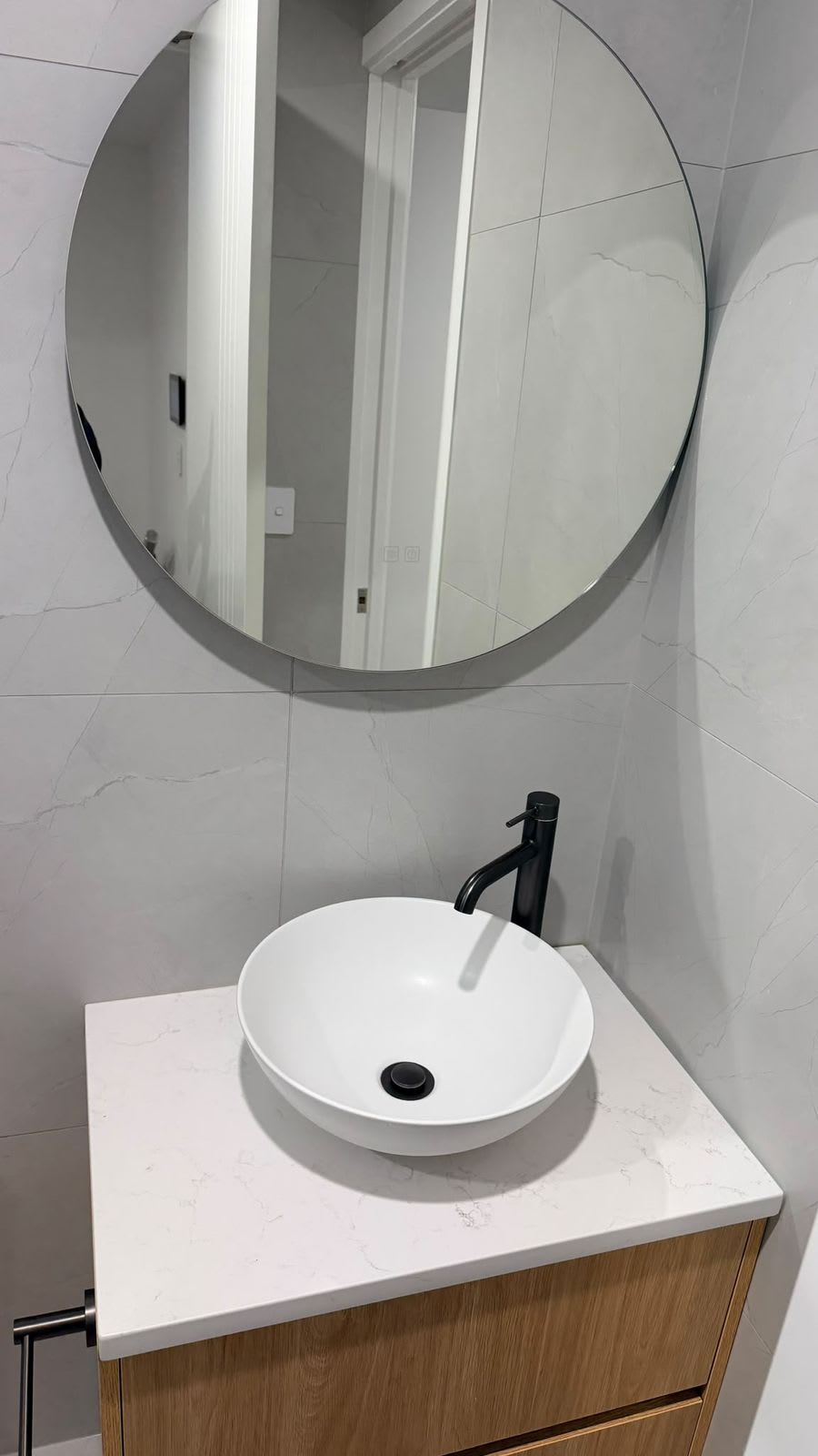 Round mirror, vessel basin and timber vanity