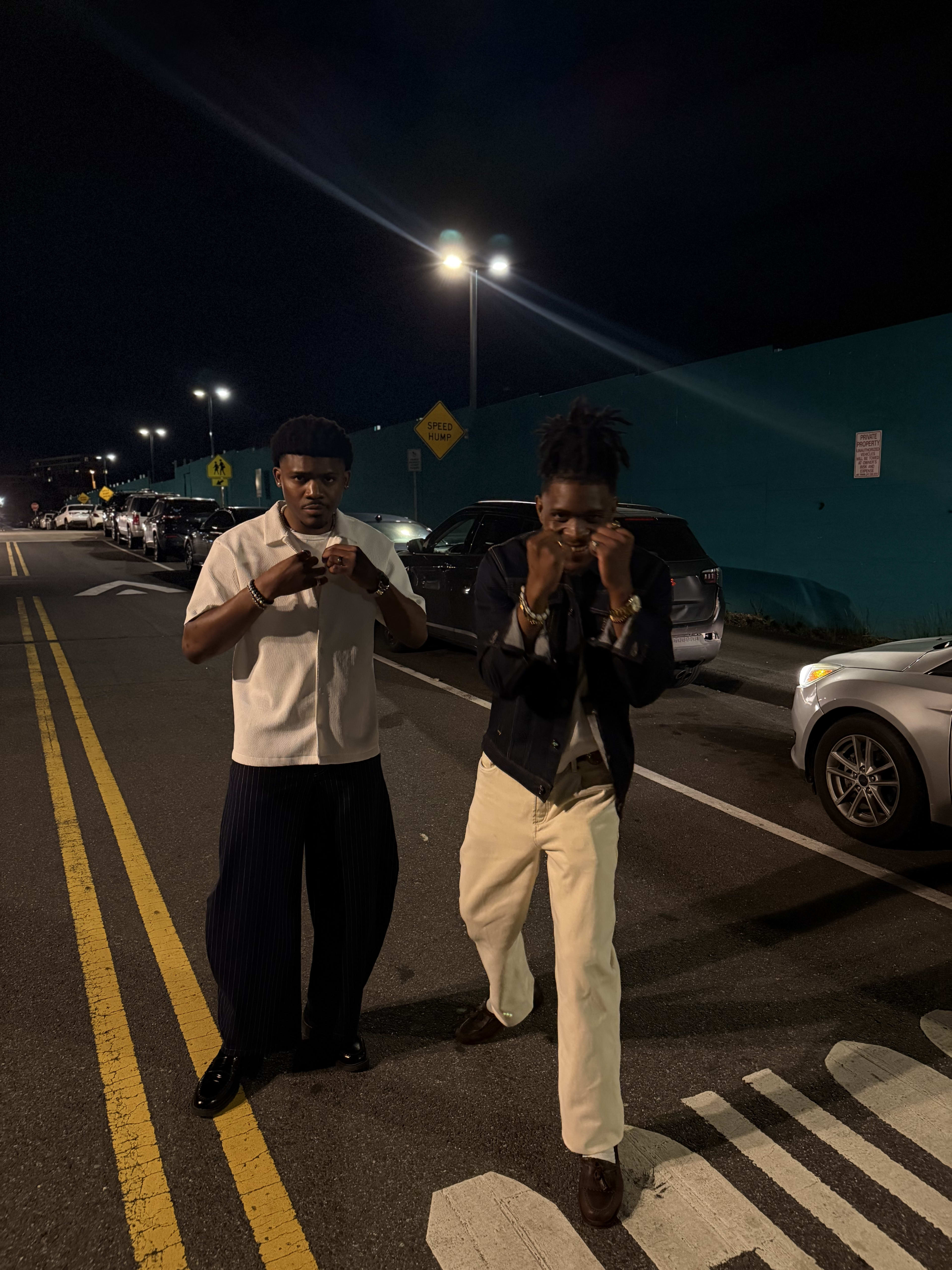 Kama and a friend playing at fisticuffs in the middle of the night street, laughing