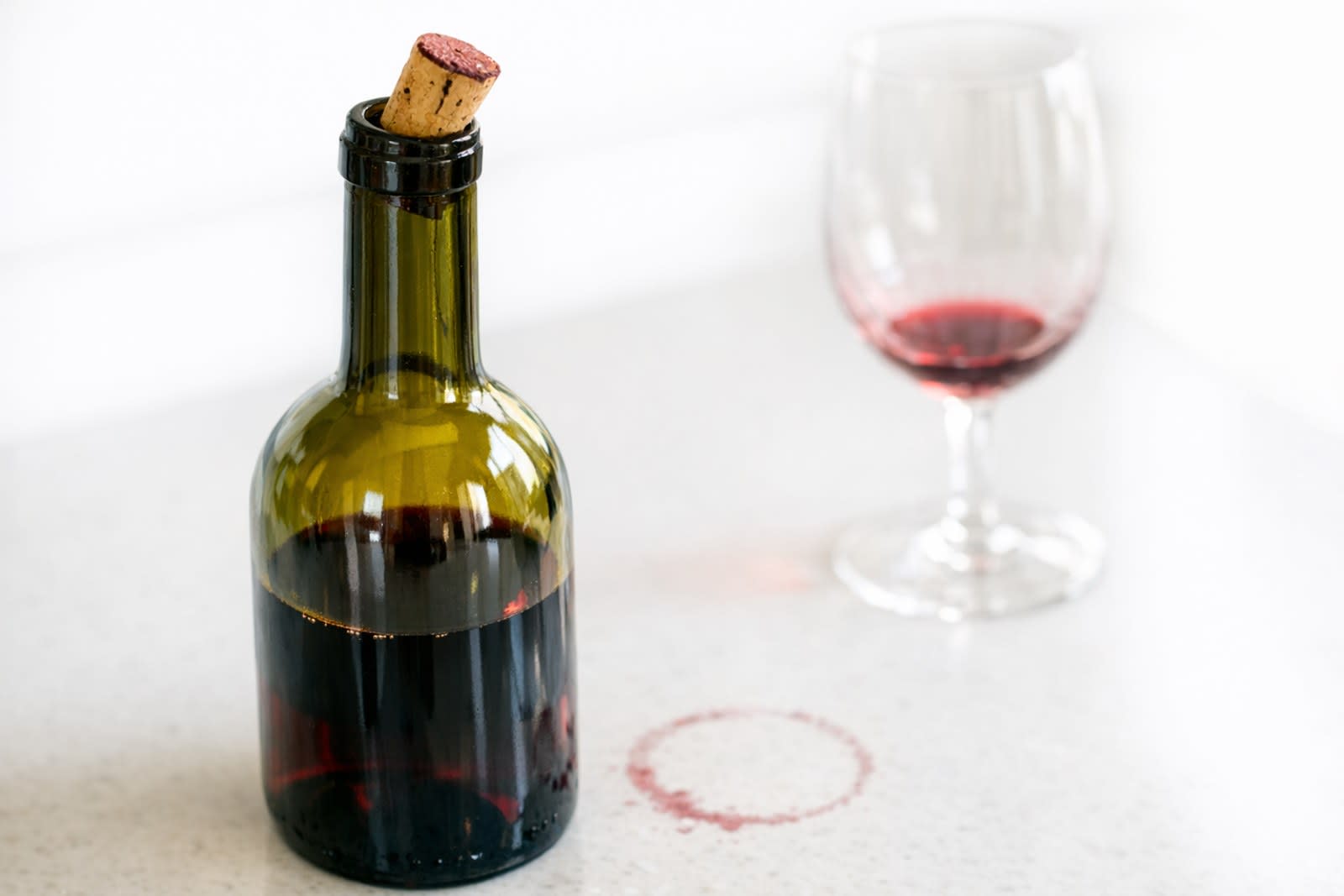 A half bottle of red wine with the cork pushed back in