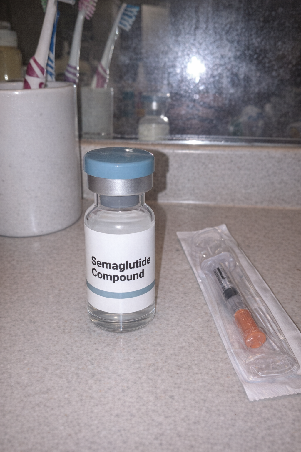 A compounded semaglutide vial on a bathroom counter