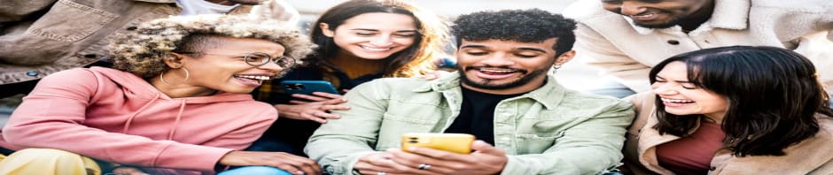 Photo of a diverse group of Gen Z friends laughing together while looking at smartphones, illustrating Gen Z statistics and trends