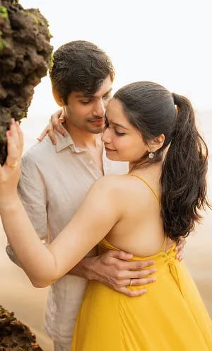 Couple walking hand in hand during pre wedding shoot at Hubli beach
