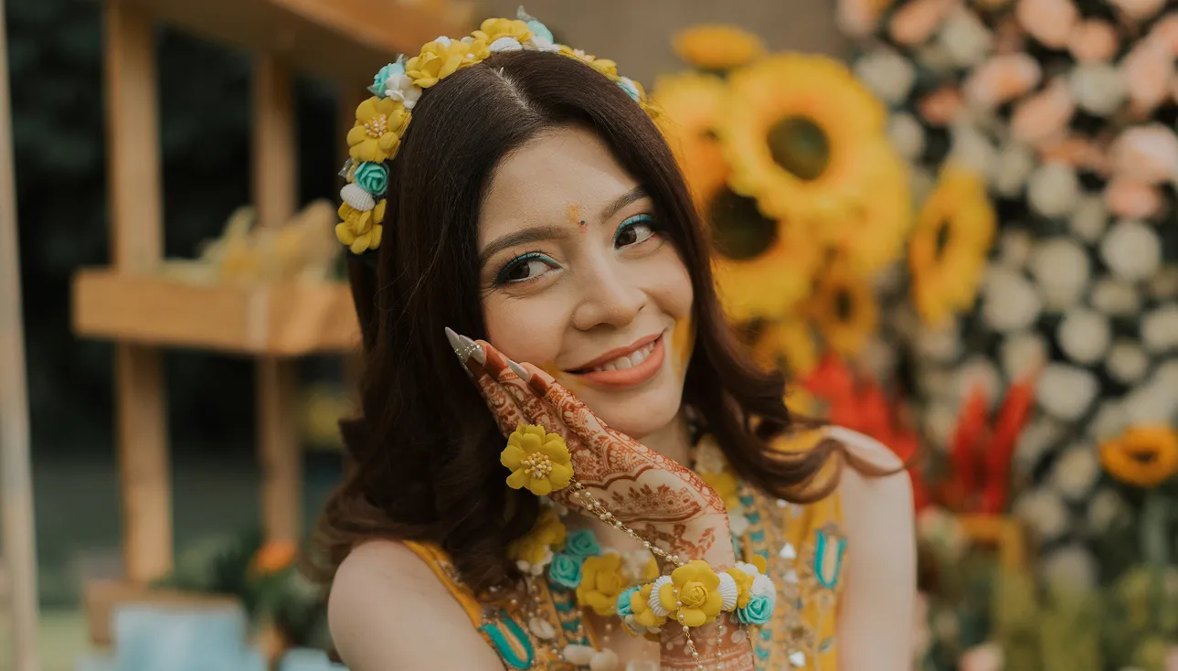 Bride smiling during traditional haldi ceremony ritual