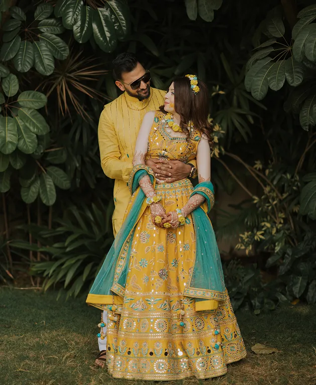 Bride wearing yellow outfit during haldi ceremony