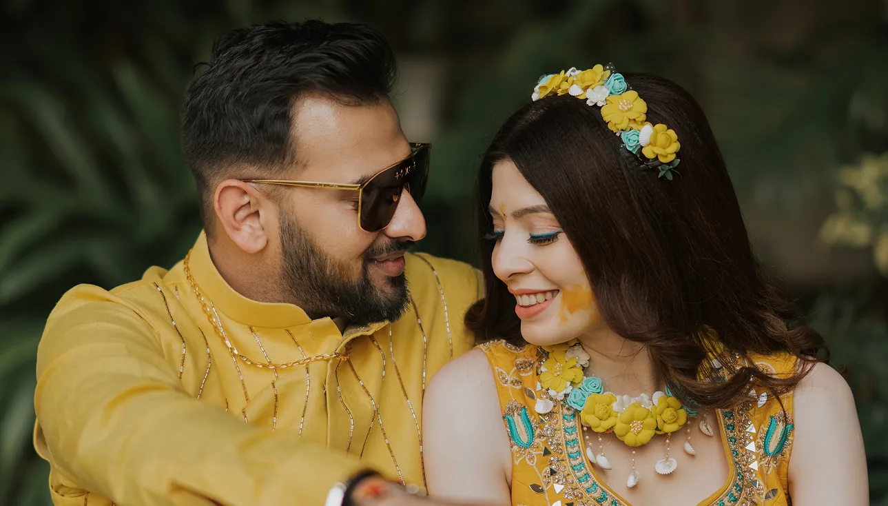 Couple posing together during haldi function celebration